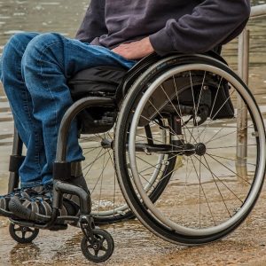 A paraplegic man sits in a wheelchair.