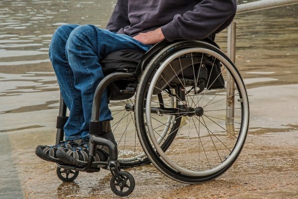 A paraplegic man sits in a wheelchair.